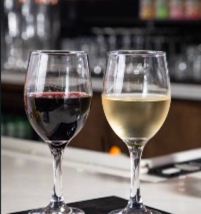 A glass of red wine and a glass of white wine on the KPOT Middletown bar counter